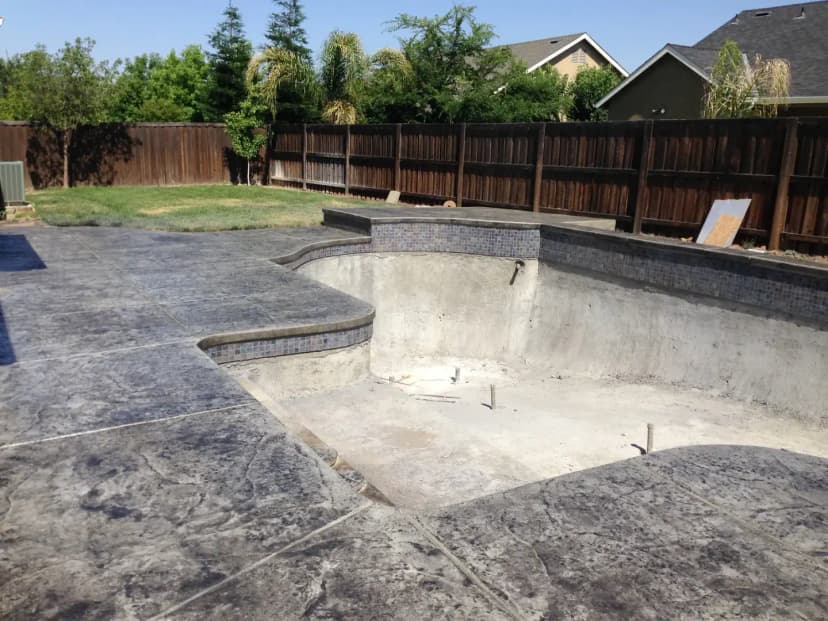 Swimming pool with stamped concrete deck and landscaping