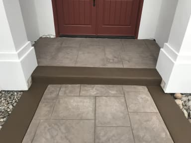Concrete entry porch and steps at residential front door