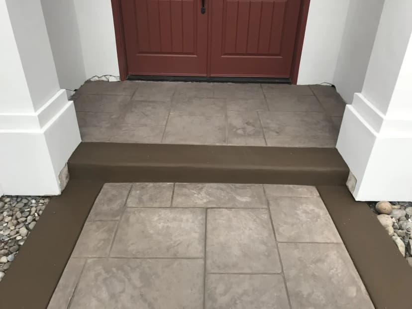 Concrete entry porch and steps at residential front door