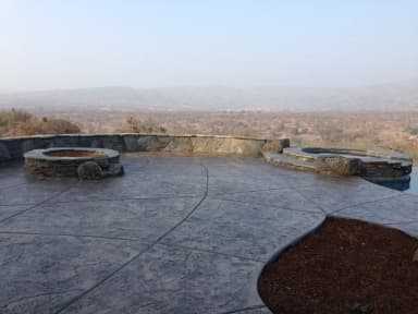 Concrete patio with circular fire pits and mountain views