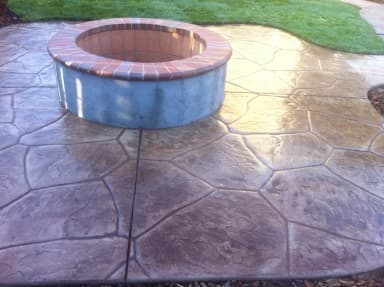 Stamped concrete patio with circular fire pit seating