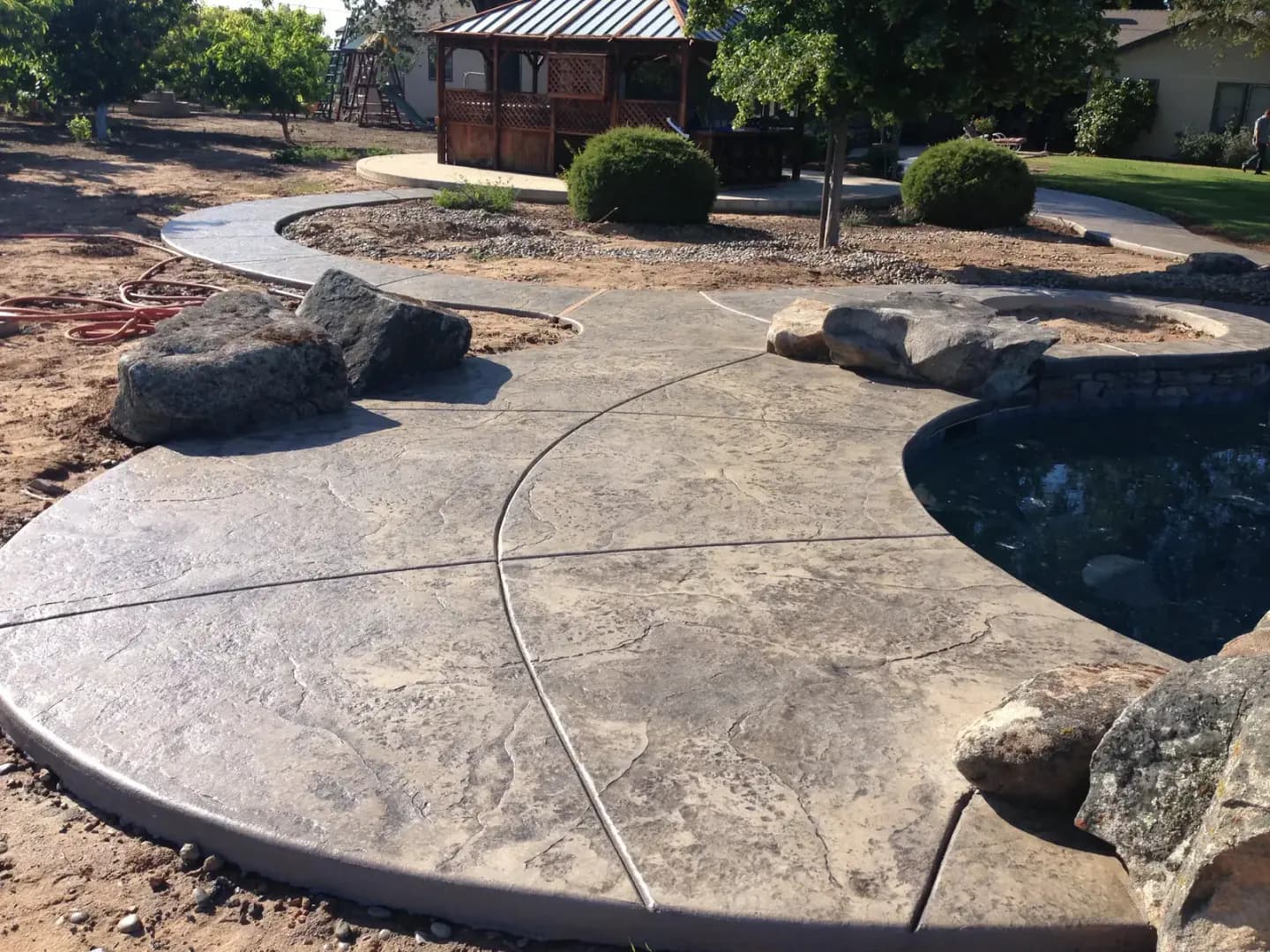 Stamped concrete driveway in front of residential garage