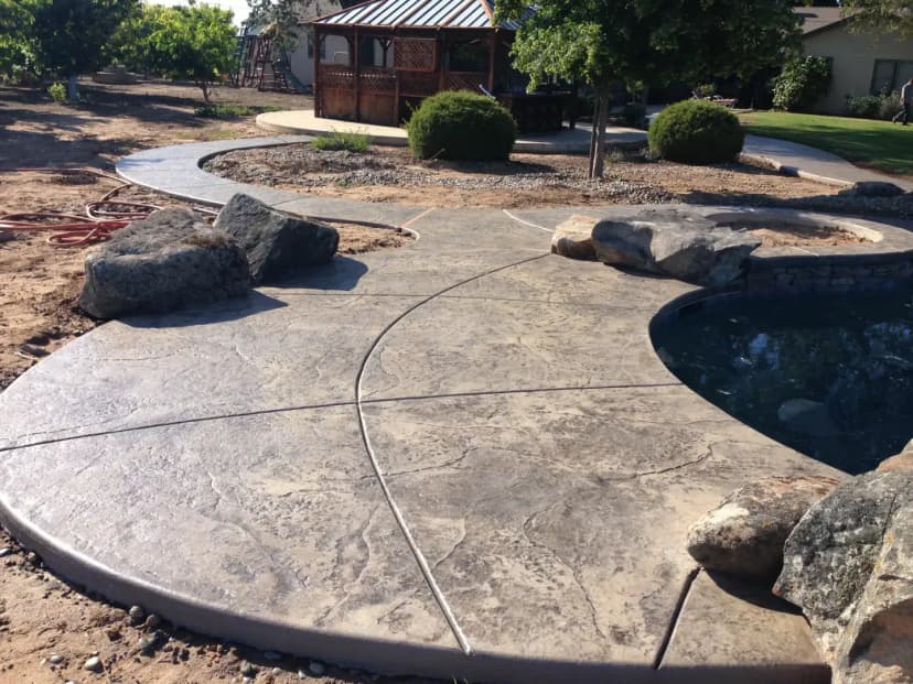Stamped concrete driveway in front of residential garage