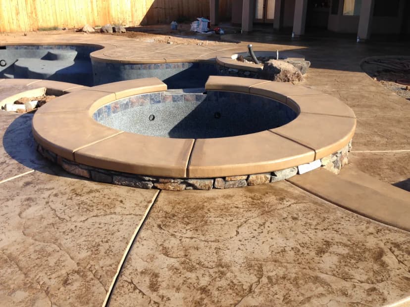 Concrete circular seating benches around fire pit feature