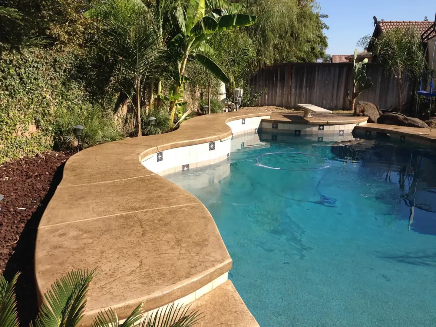 Covered patio with stamped concrete and pool