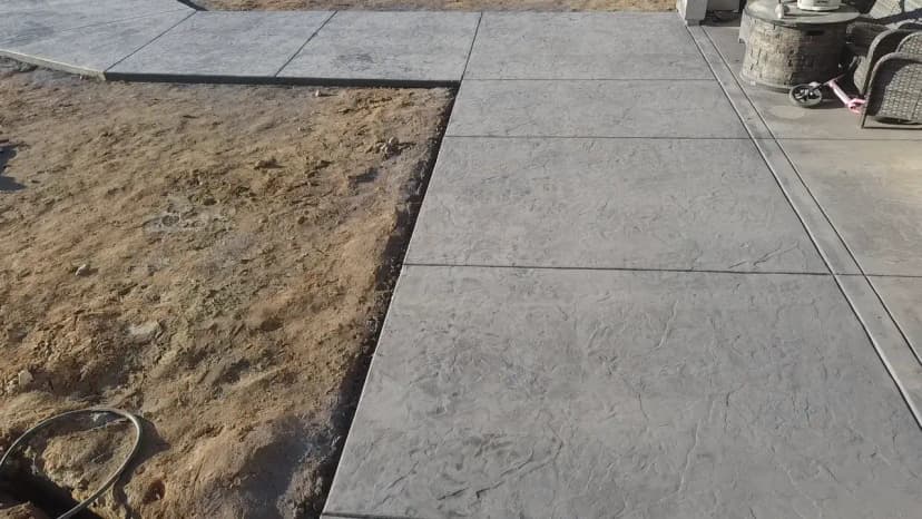 Concrete patio in progress near landscaping