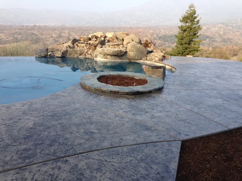 Scenic pool with spa and concrete overlooking valley