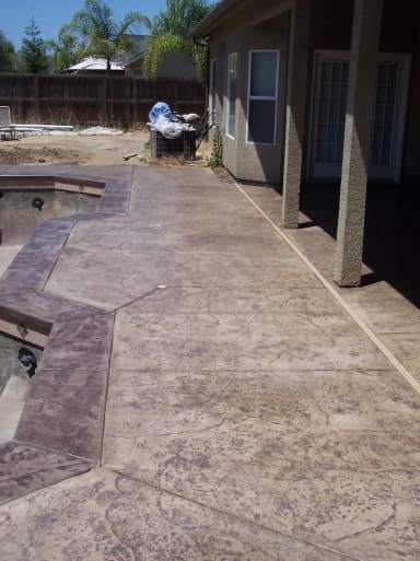 Stamped concrete walkway along house