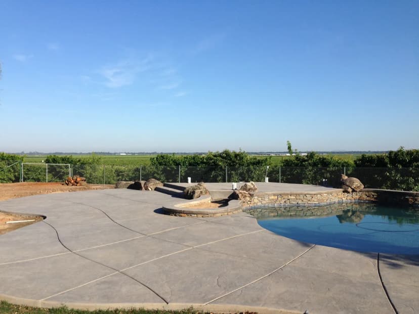 Scenic pool with concrete overlook and spa
