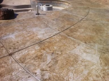 Backyard concrete patio with landscaping