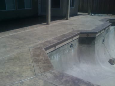 Stamped concrete bench with textured top surface.