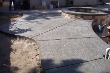 Concrete patio with decorative finish and fire ring area.
