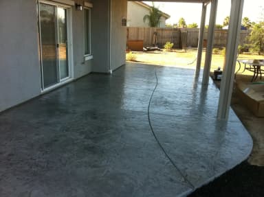 Covered patio with textured concrete floor.