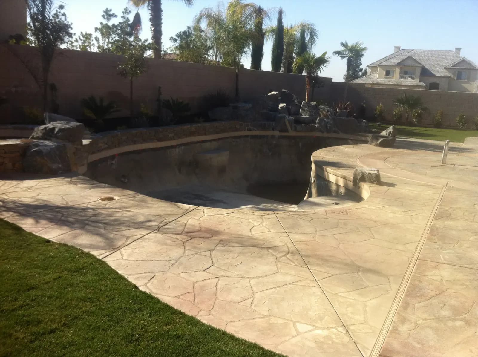 Backyard pool and spa area with concrete deck.