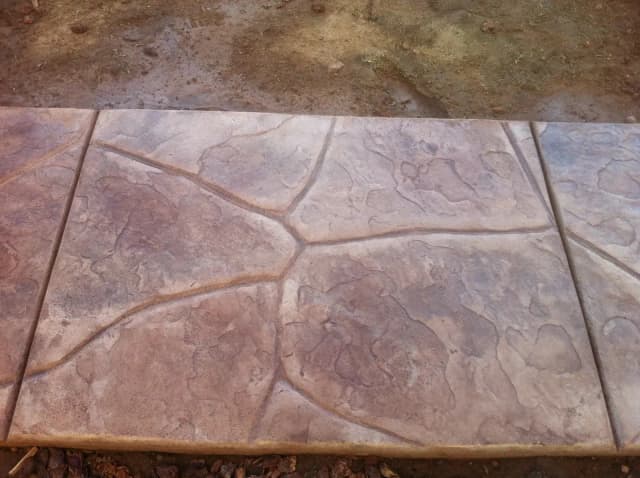 Stamped concrete with stone pattern texture detail.