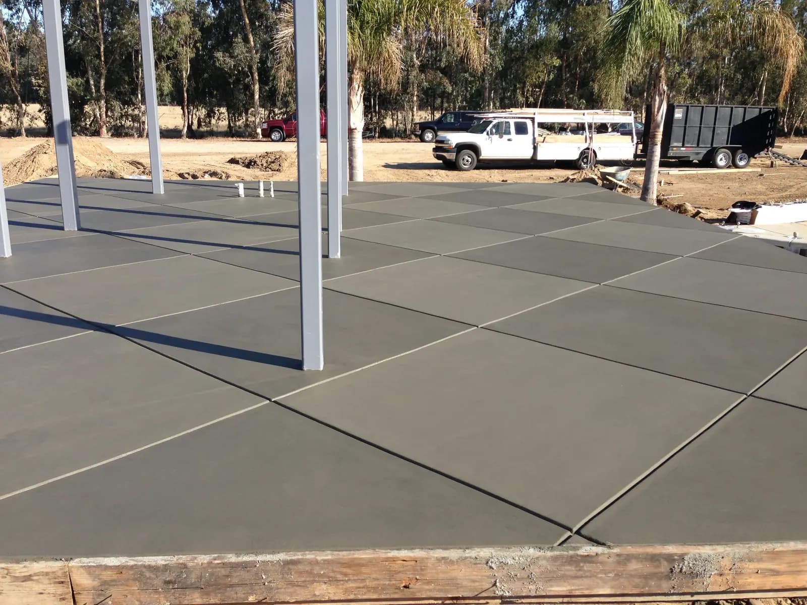 Covered patio with smooth concrete floor and pergola.