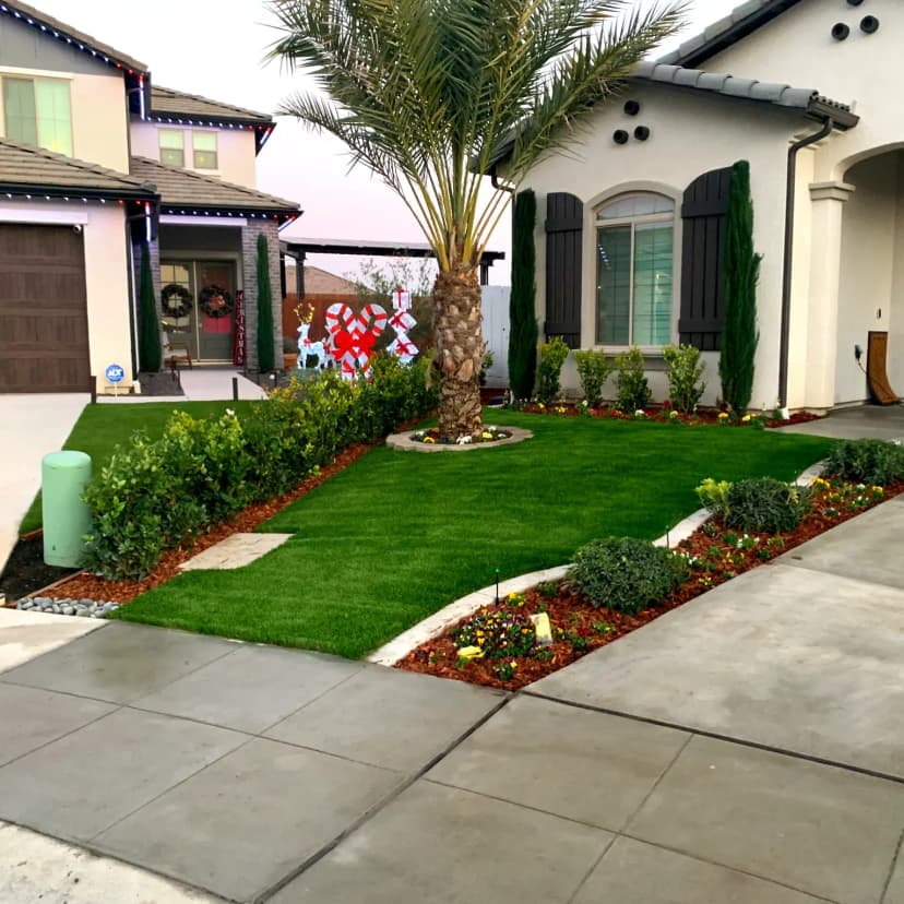 Front yard driveway with concrete and landscaping