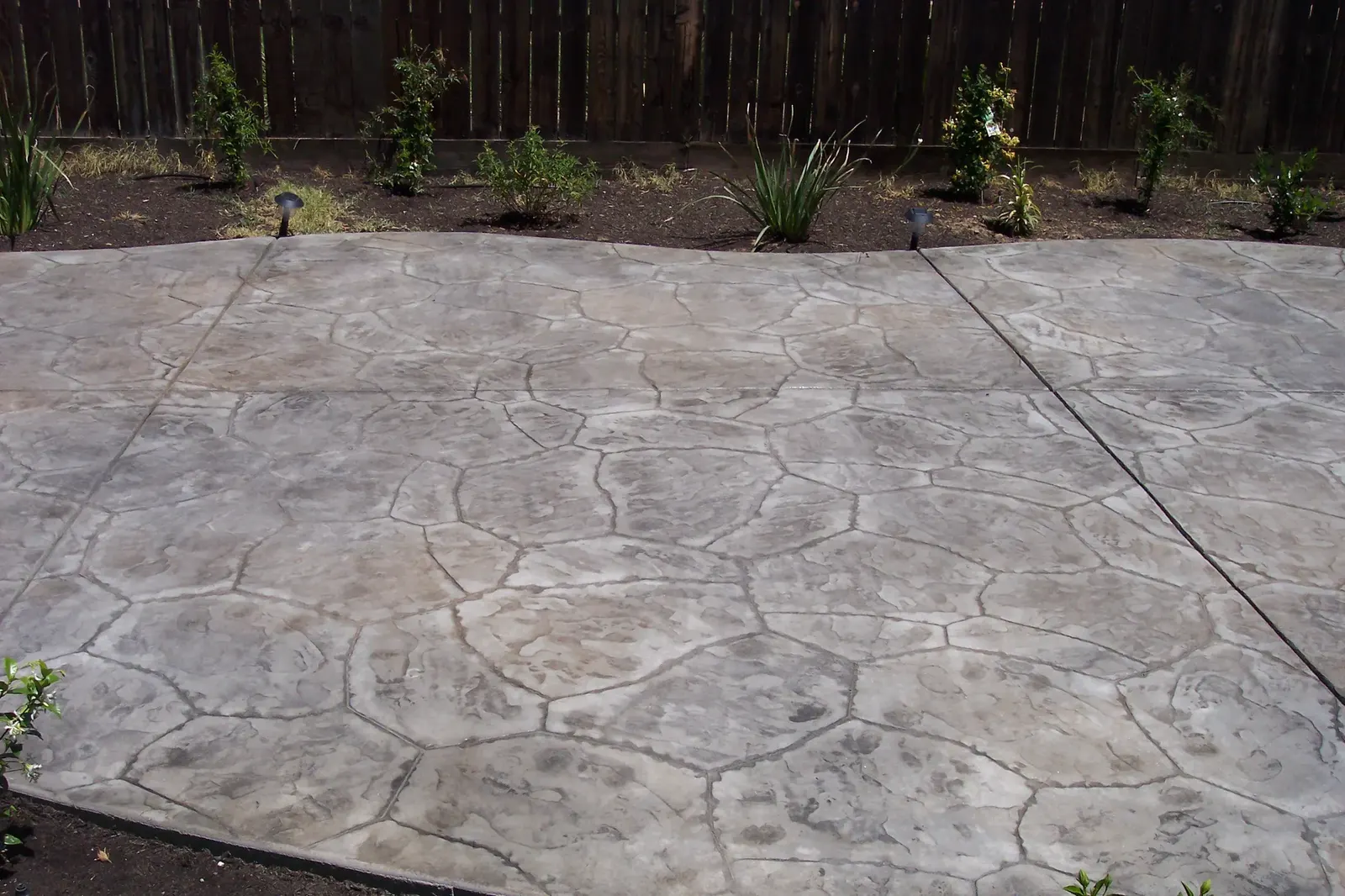 Decorative stamped concrete backyard patio area
