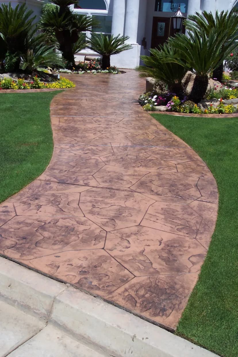 Curved stamped pathway approaching front entry