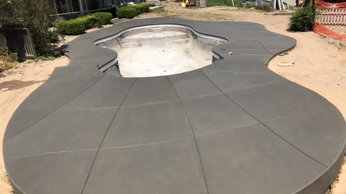 Colored stamped concrete walkway through landscape