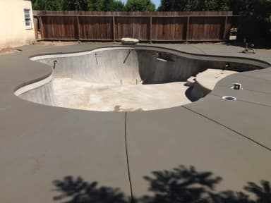 Concrete patio pad in backyard landscape