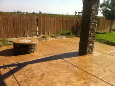 Fire pit and decorative concrete patio under structure