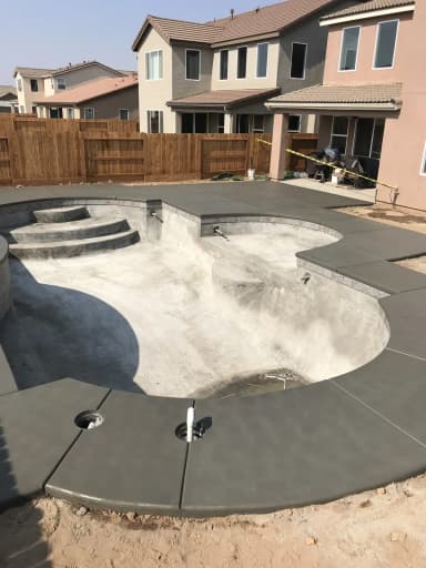 Pool with waterfall and decorative concrete patio