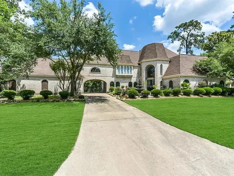 Wide concrete driveway leading to residential estate