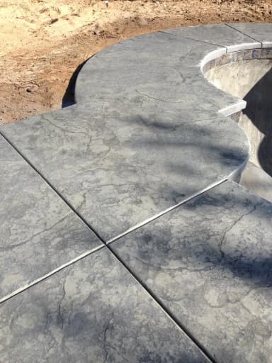 Concrete flatwork pad with saw-cut lines