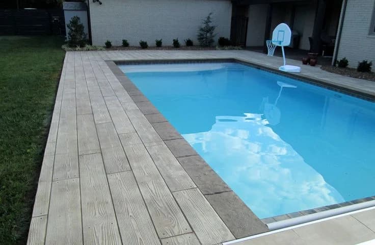 Pool deck with wood-pattern concrete decking