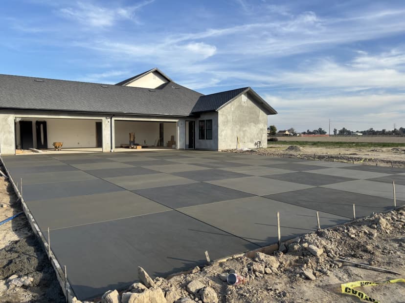 Freshly poured concrete patio slab at a new home
